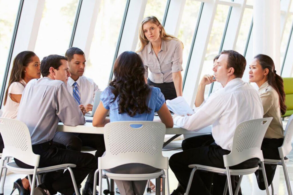 A group of people sitting around a table.