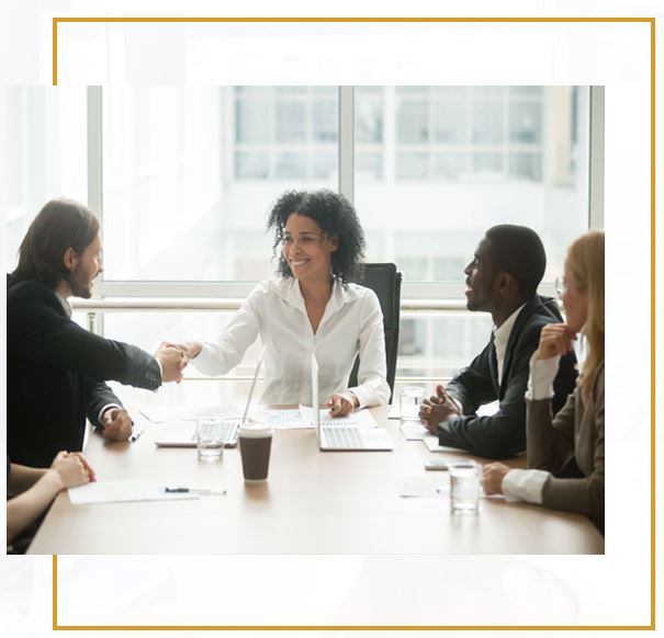 A group of people sitting around a table.